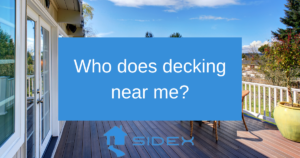 Outdoor deck with white railings and scenic view, featuring the text "Who does decking near me?" and the Sidex logo.